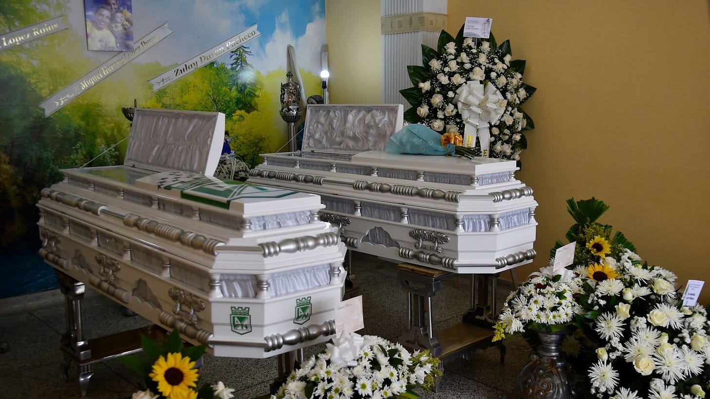 The coffins with the bodies of Miguel Ángel López Rojas, his wife Zulay Durán Pacheco, and their nine-month-old baby are seen as they are being mourned by relatives after they were murdered by armed groups operating in the area of Cúcuta, Colombia, on Friday.