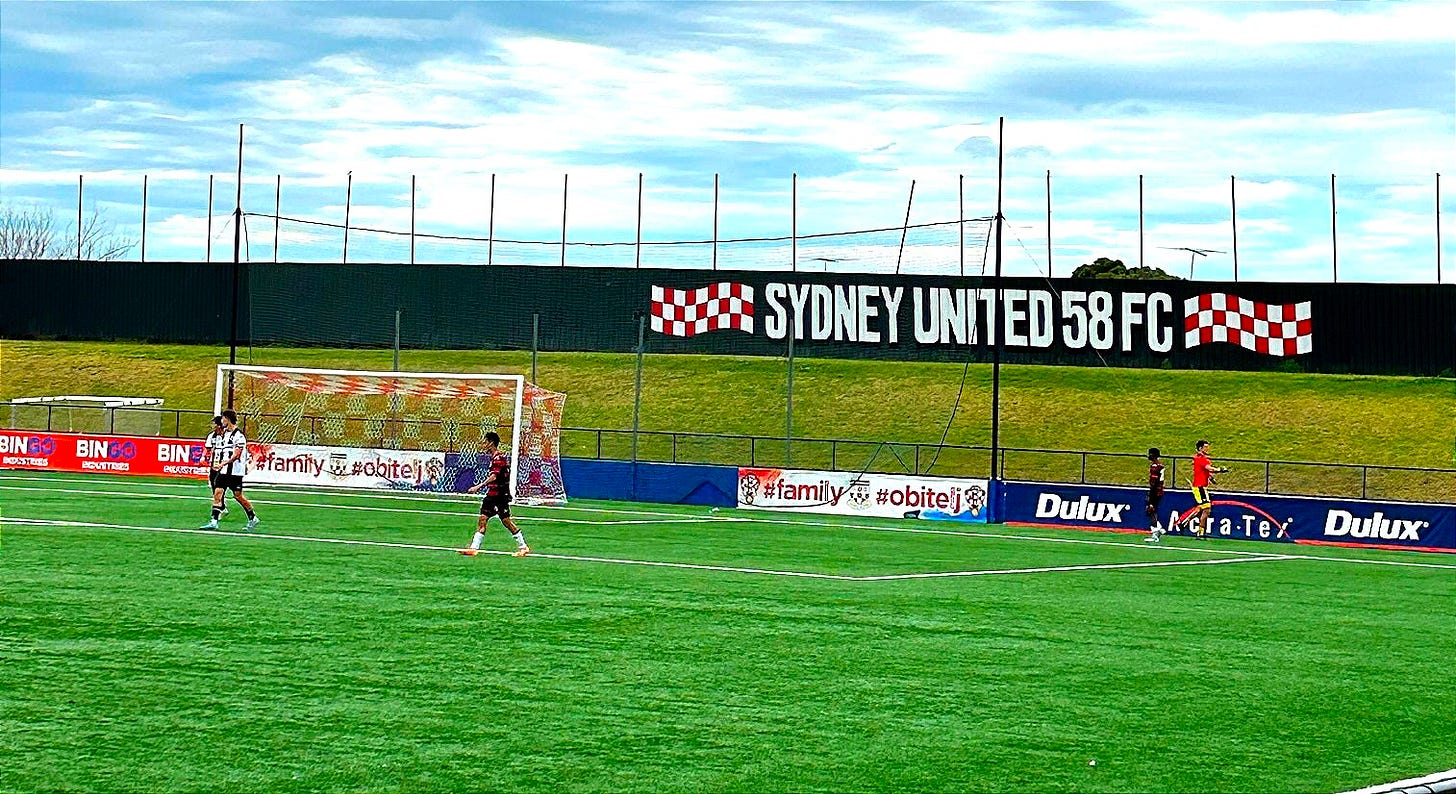 Match scene at Sydney United sports centre with Croatian red and white checks