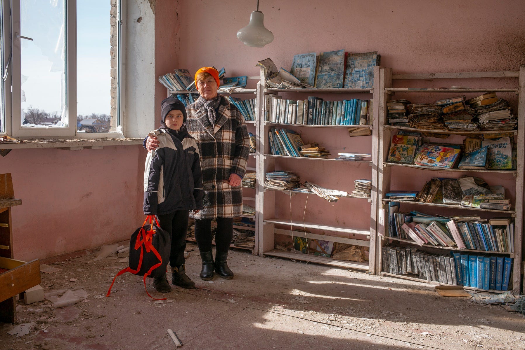 Grandmother and Grandson in a damaged library, from “Kherson – It’s personal”. © Danny Burrows.