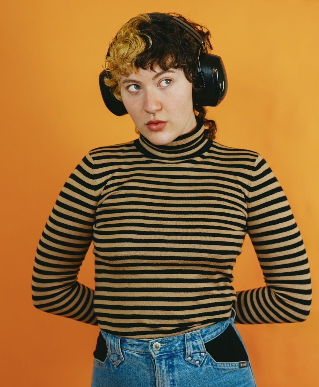 Portrait of a nonbinary autistic person in a studio setting using headphones Portrait of a nonbinary autistic person in a studio setting using headphones