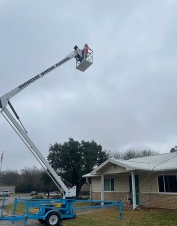 Photos of the halls roof while pressure washing and me enjoying my ride on the lift.