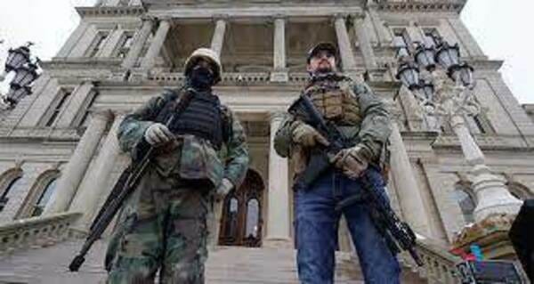 Armed men stand on the steps at the State Capitol after a rally in support of President Trump in Lansing, Michigan, on Jan. 6, 2021. (Paul Sancya/AP) Armed men stand on the steps at the State Capitol after a rally in support of President Trump in Lansing, Michigan, on Jan. 6, 2021. (Paul Sancya/AP)