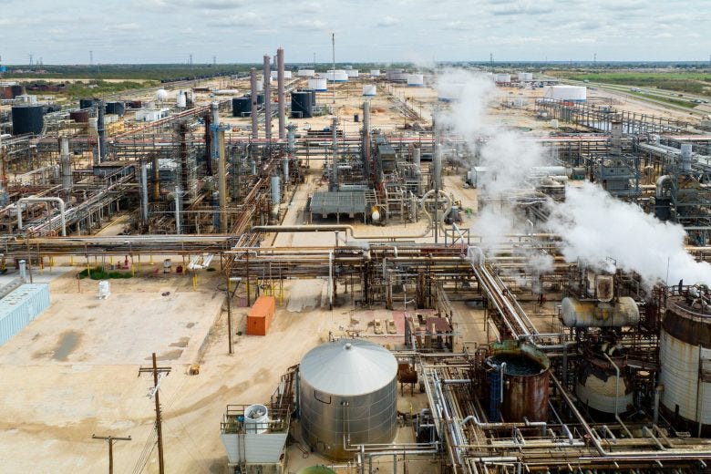 color outdoor photograph of an oil refinery in an arid environment