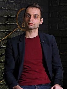 A person sitting in front of a brick wall

AI-generated content may be incorrect.