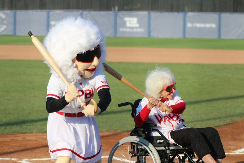 99 year old Maybelle Blair in WPBL jersey poses with her mascot lookalike. 99 year old Maybelle Blair in WPBL jersey poses with her mascot lookalike.