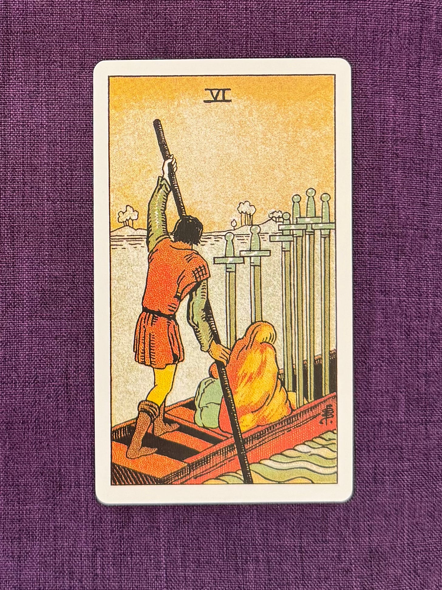 A small boat moves across a body of water. A figure stands at the back of the boat, holding a long pole to guide it forward. In front, a seated figure is hunched over, with a smaller figure close beside them. Six upright swords are arranged in the front of the boat, their blades pointing upward. The water is calm in the foreground and more textured in the distance. No land is visible nearby.