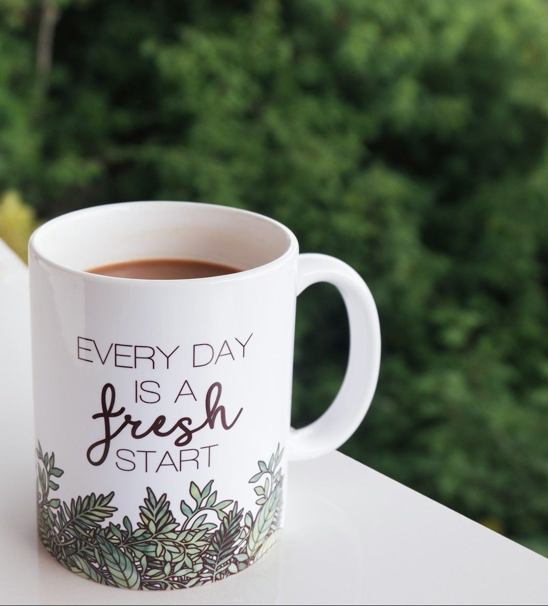 Coffee mug with a scenic mountain background.