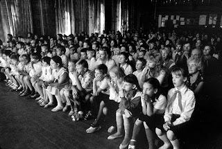 an audience raptly watching the play "Peace Child"