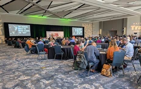 A group of people sitting in a room

AI-generated content may be incorrect.