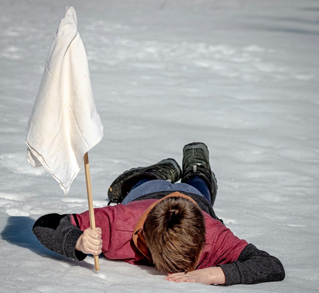 woman in black jacket lying on white snow woman in black jacket lying on white snow