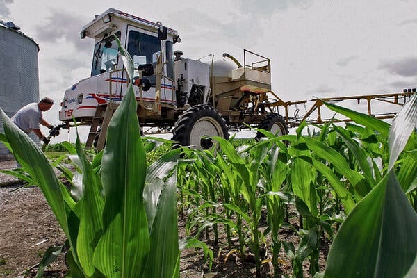 A tractor rigged with spraying equipment.