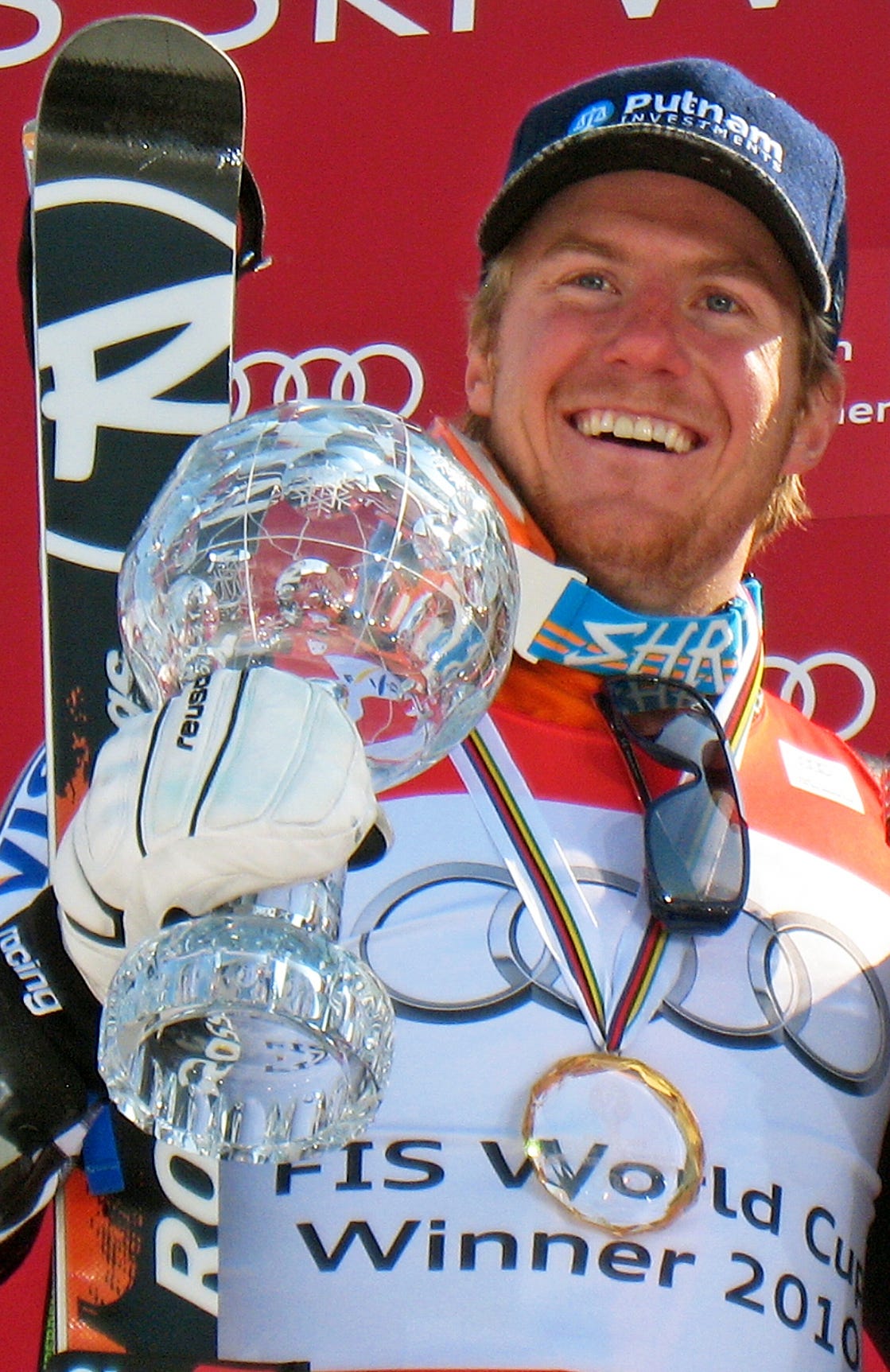 Ted Ligety smiling with a crystal globe trophy and a medal Ted Ligety smiling with a crystal globe trophy and a medal