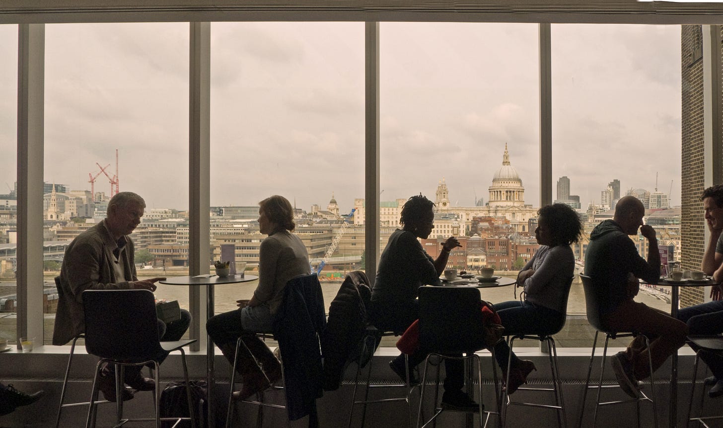 cafe tables and people against view of St Paul's Cathedral