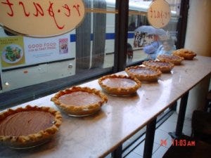 A counter full of pies with flaky pie crust at Repast Bakery in NYC.
