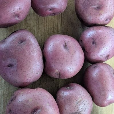 Pictures of meat and whole and sliced potatoes