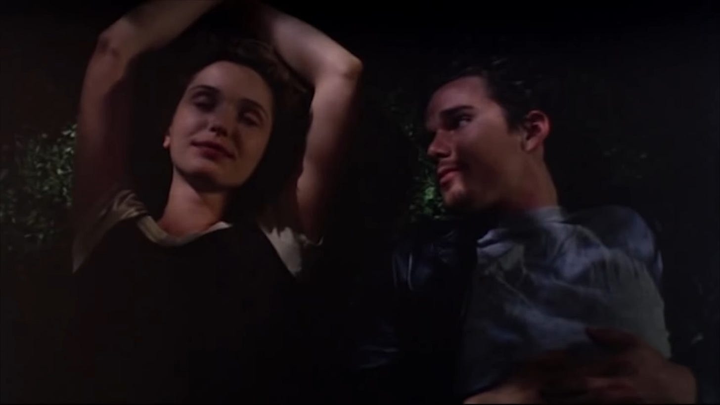 Still from BEFORE SUNRISE with Julie Delpy and Ethan Hawke lying in the grass