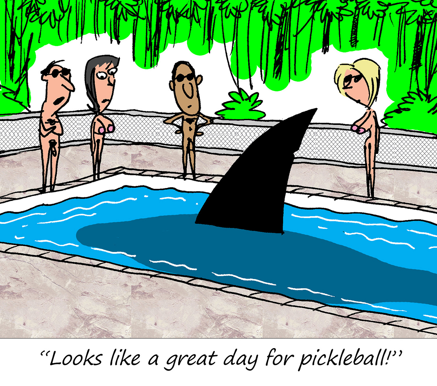 A cartoon shows four nude people standing around a swimming pool, staring at a large shark fin in the water. The caption at the bottom reads: “Looks like a great day for pickleball!”