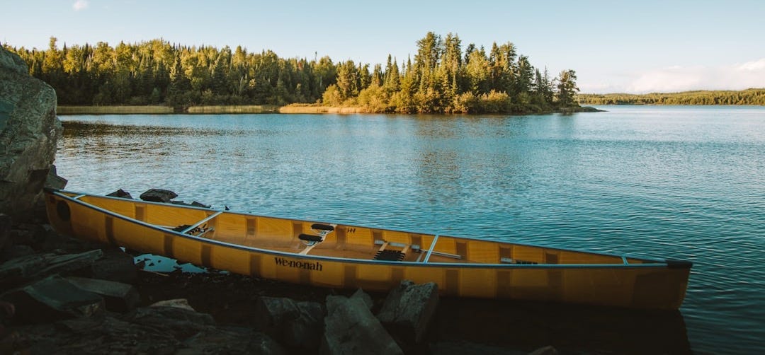 yellow canoe on body of water