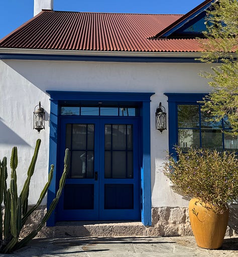 The photos display nine homes in the Sonoran architectural style traditional to the Southwest of the United States. The homes feature flat roofs, front walls that begin at the sidewalk's edge, colorful stucco exterior walls, and large windows.