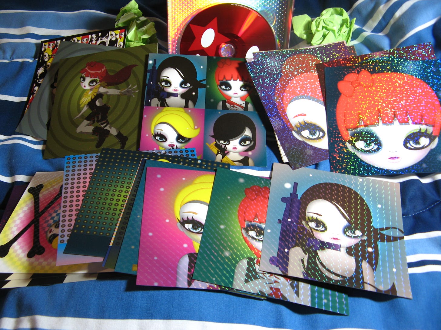 2NE1's 2nd Mini Album comes with a slew of mini little postcard things some have lyrics and song info on the back.