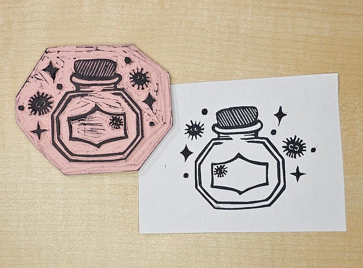 Four photos of a custom made stamp featuring an ink bottle, soot sprites, and sparkles.