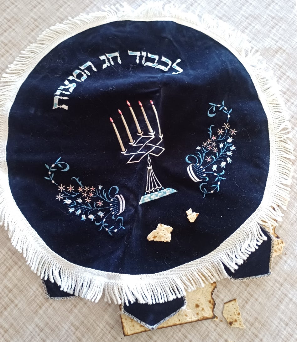 Blue matzo cover with some broken matzo on and in it