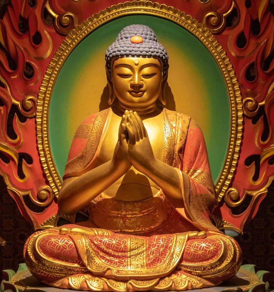 red and gold great buddha ceramic figurine in closeup photo