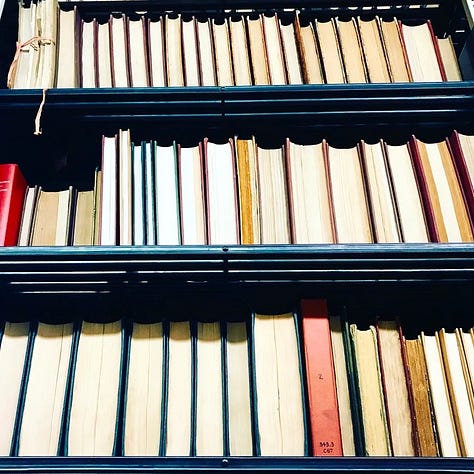 Three photos of library shelves full of books.