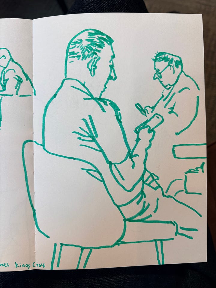 Drawings of men looking at phones drawn from life