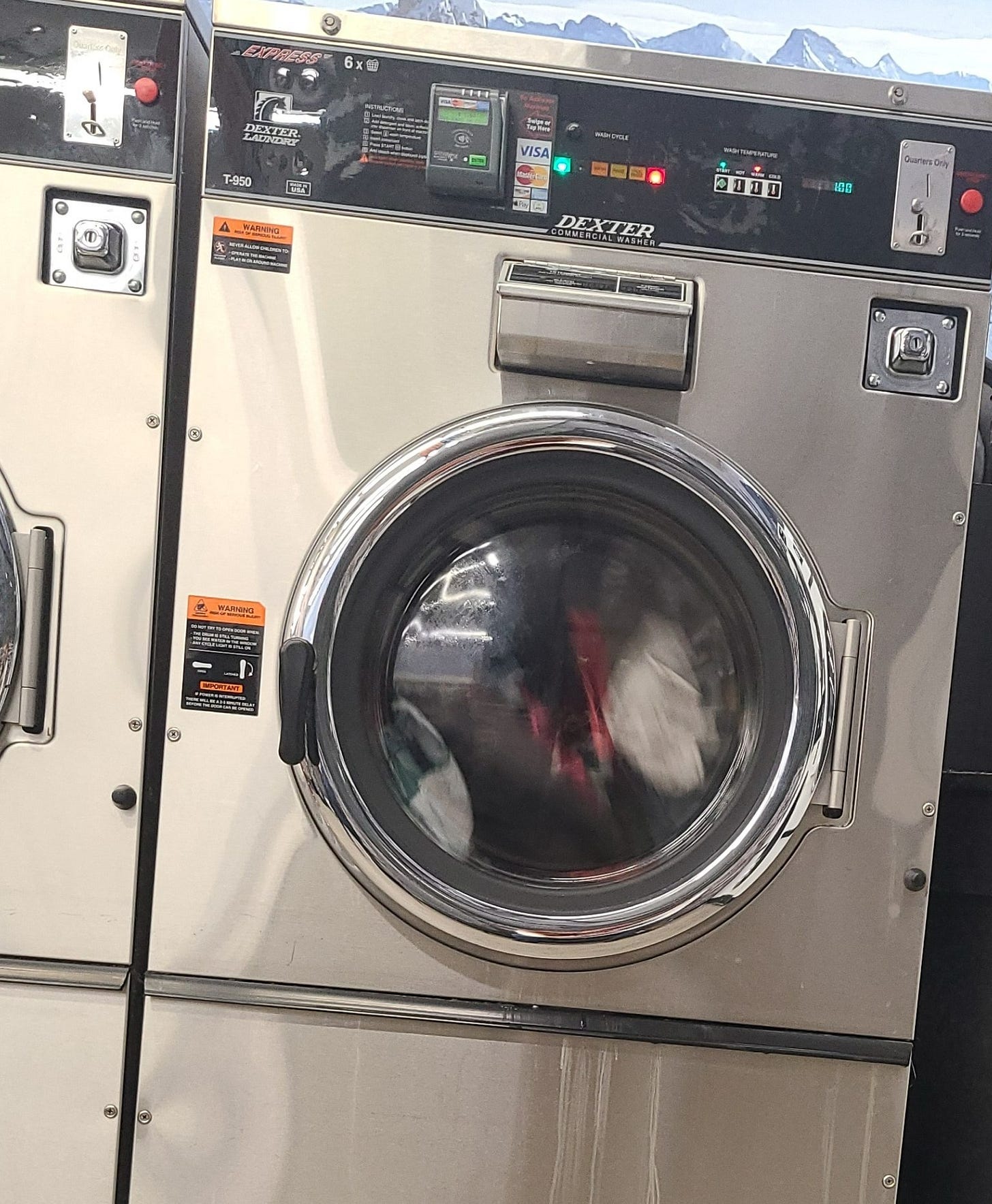 Commercial washing machine with mountain wallpaper in the background
