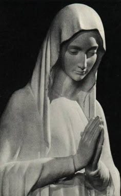 This may contain: a black and white photo of a woman with her hands folded in front of her face