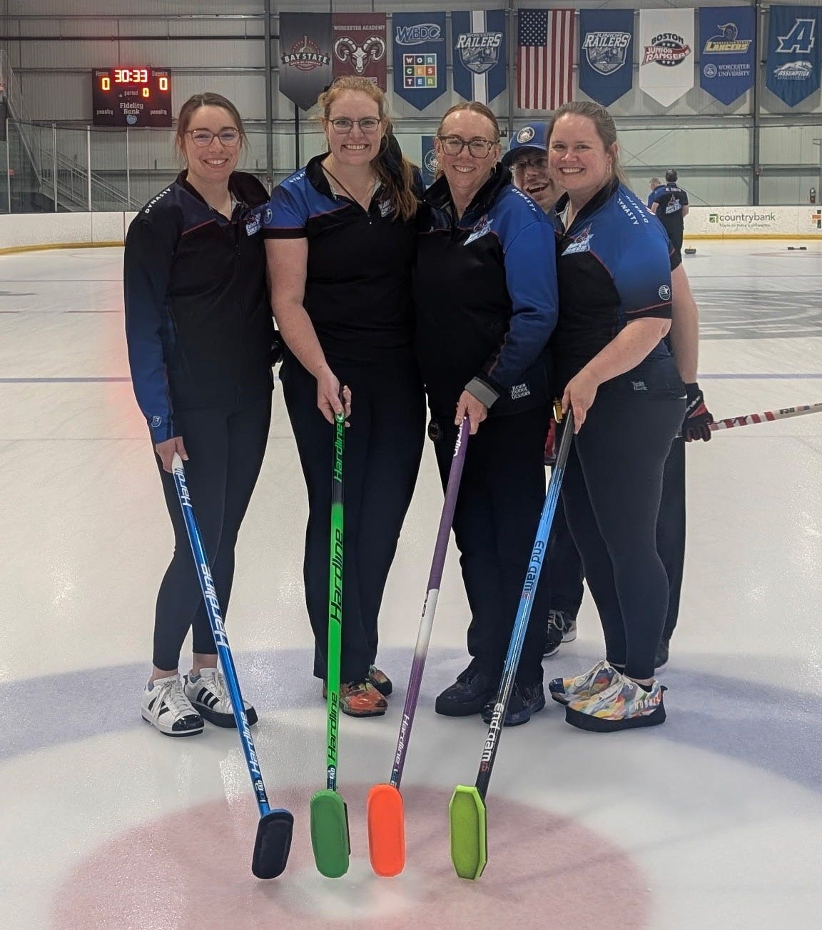 May be an image of 4 people, people playing hockey, people skating and text