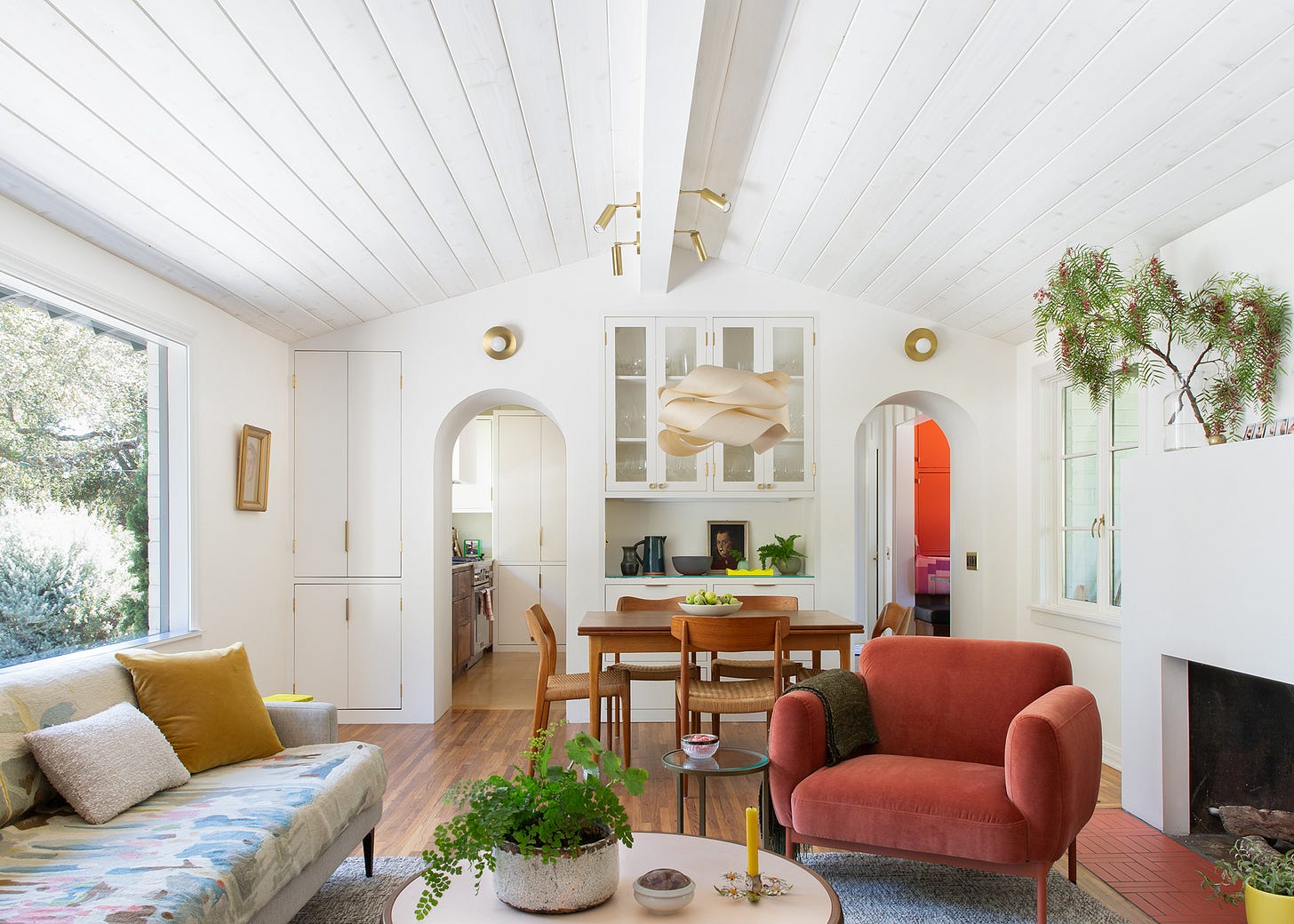 Living room with built-in storage and vaulted ceiling