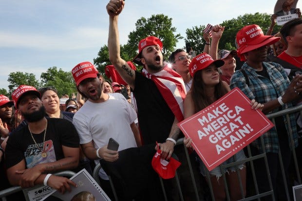 Supporters of former President Donald Trump watch as he holds a rally in the historical Democratic district of the South Bronx on May 23, 2024 in New York City.