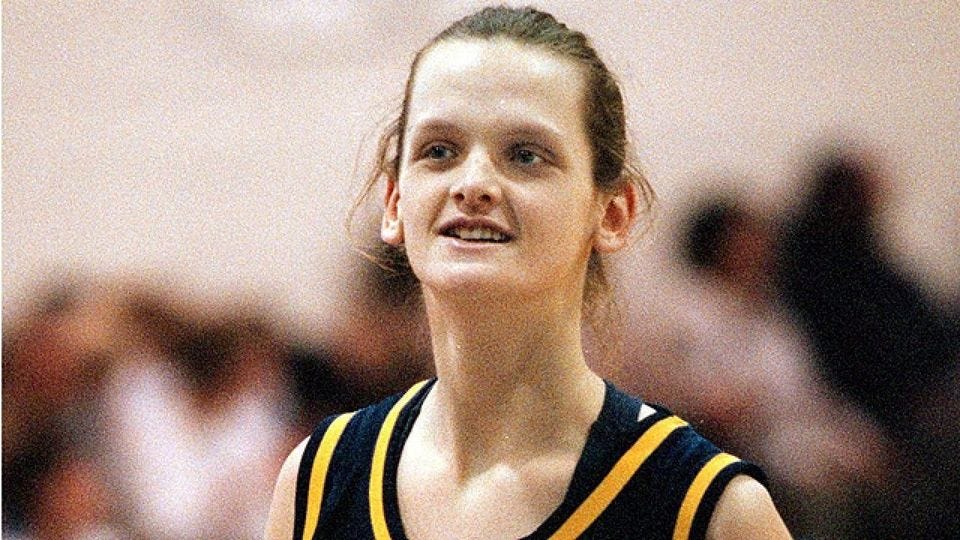 May be an image of 1 person, playing basketball and basketball jersey
