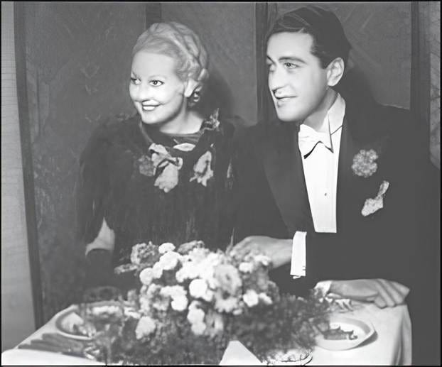 A person and person sitting at a table

Description automatically generated