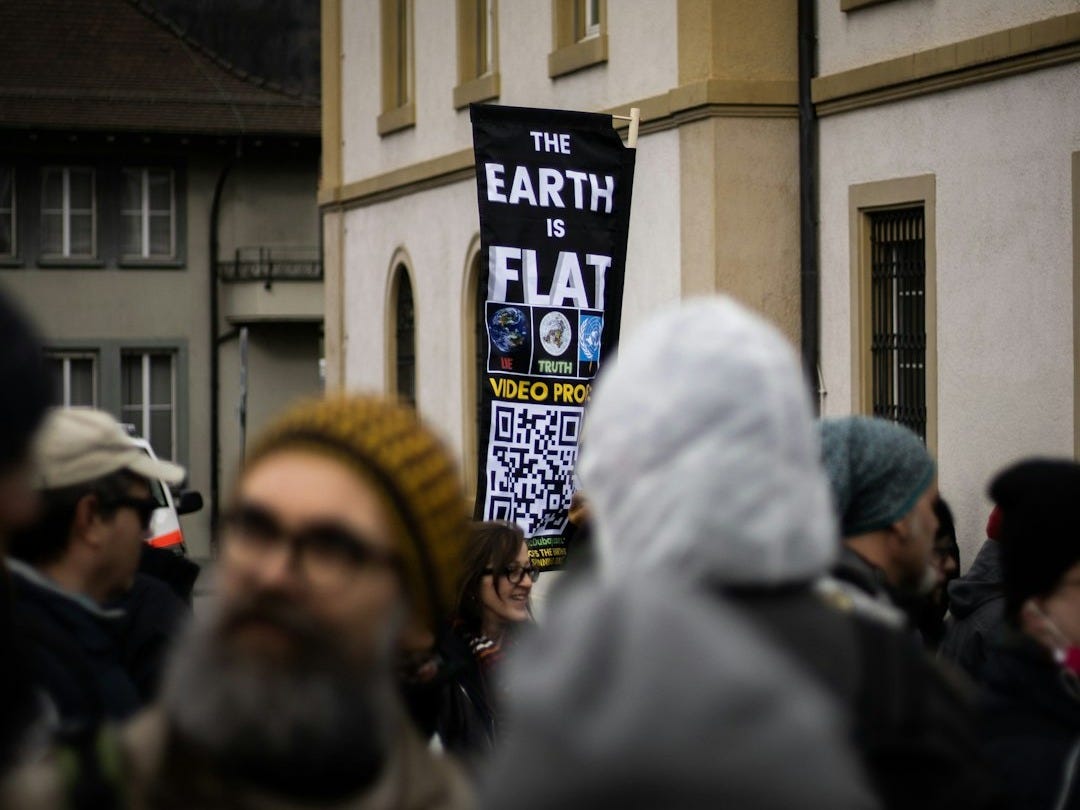 people in white and yellow hijab standing in front of building during daytime