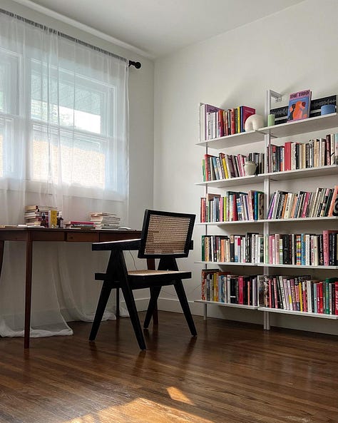 an office; drinks outside on a tray table; a fireplace and a bookshelf.