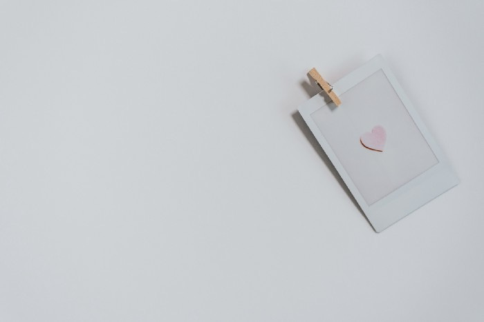 A card with a clothesline attached to it. There are three sections: a white background, a pink smaller rectangle attached to the clothesline, and a heart in the center. A card with a clothesline attached to it. There are three sections: a white background, a pink smaller rectangle attached to the clothesline, and a heart in the center.