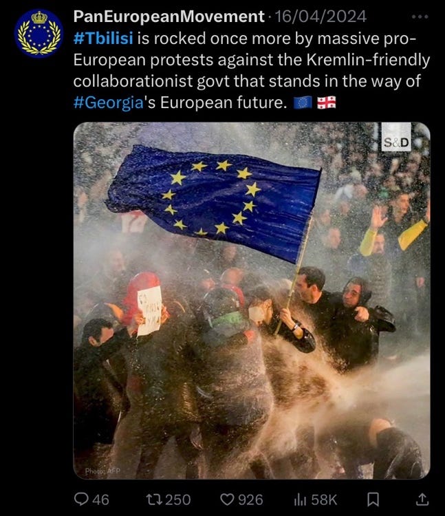 A group of people holding a flag

Description automatically generated