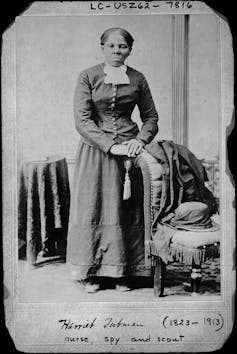 Black and white portrait of Black woman in 19th-century dress