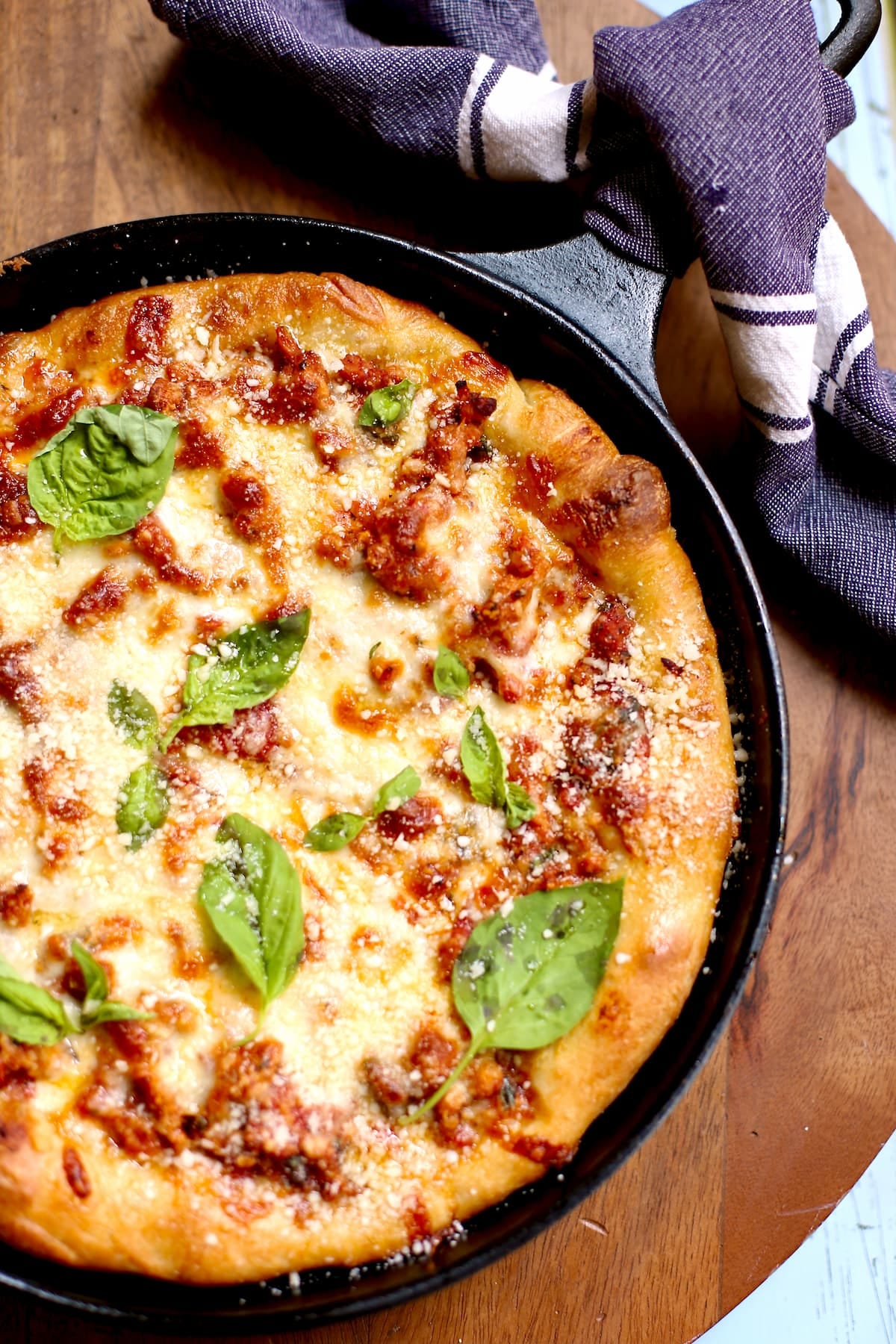 a pizza in lodge cast iron on a table.