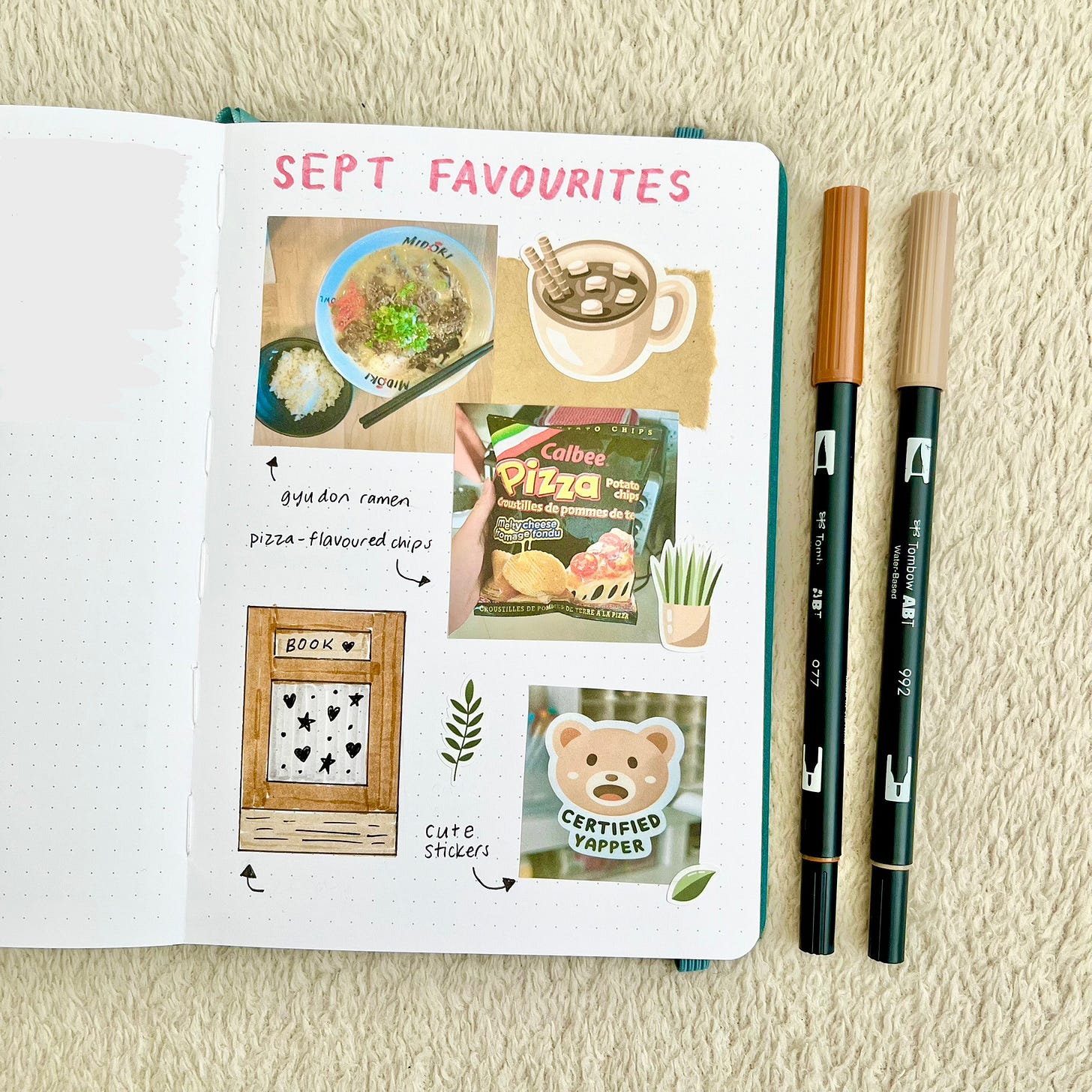 A journal page titled “Sept Favourites” with photos and drawings. Two brown markers are on the right of the page.