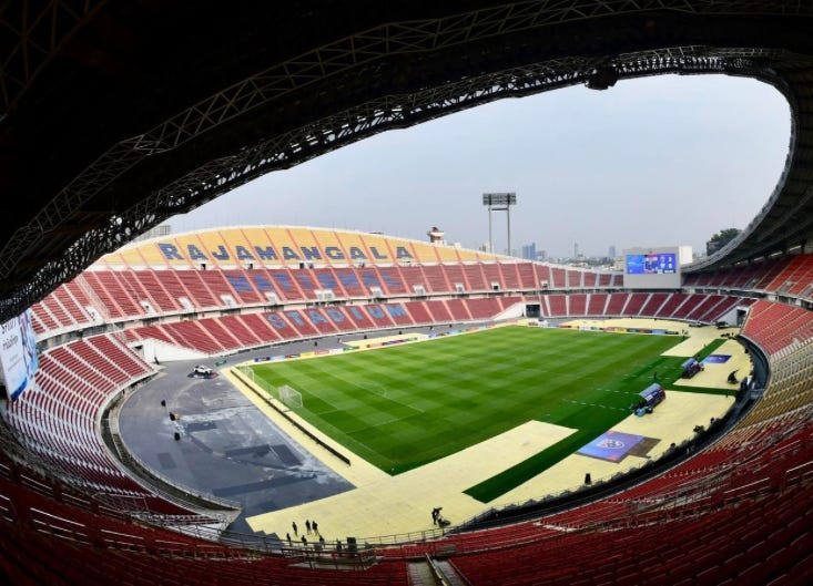 Rajamangala National Stadium in Bangkok, Thailand, featuring bright yellow and orange stands and a green football field, venue for the 33rd SEA Games 2025 opening and closing ceremonies. Rajamangala National Stadium in Bangkok, Thailand, featuring bright yellow and orange stands and a green football field, venue for the 33rd SEA Games 2025 opening and closing ceremonies.