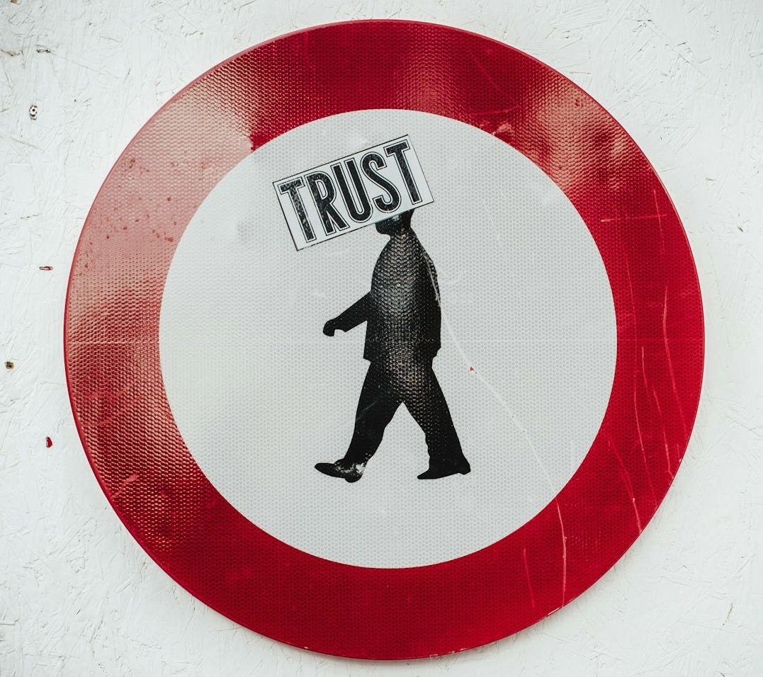 round red and white Trust signage round red and white Trust signage