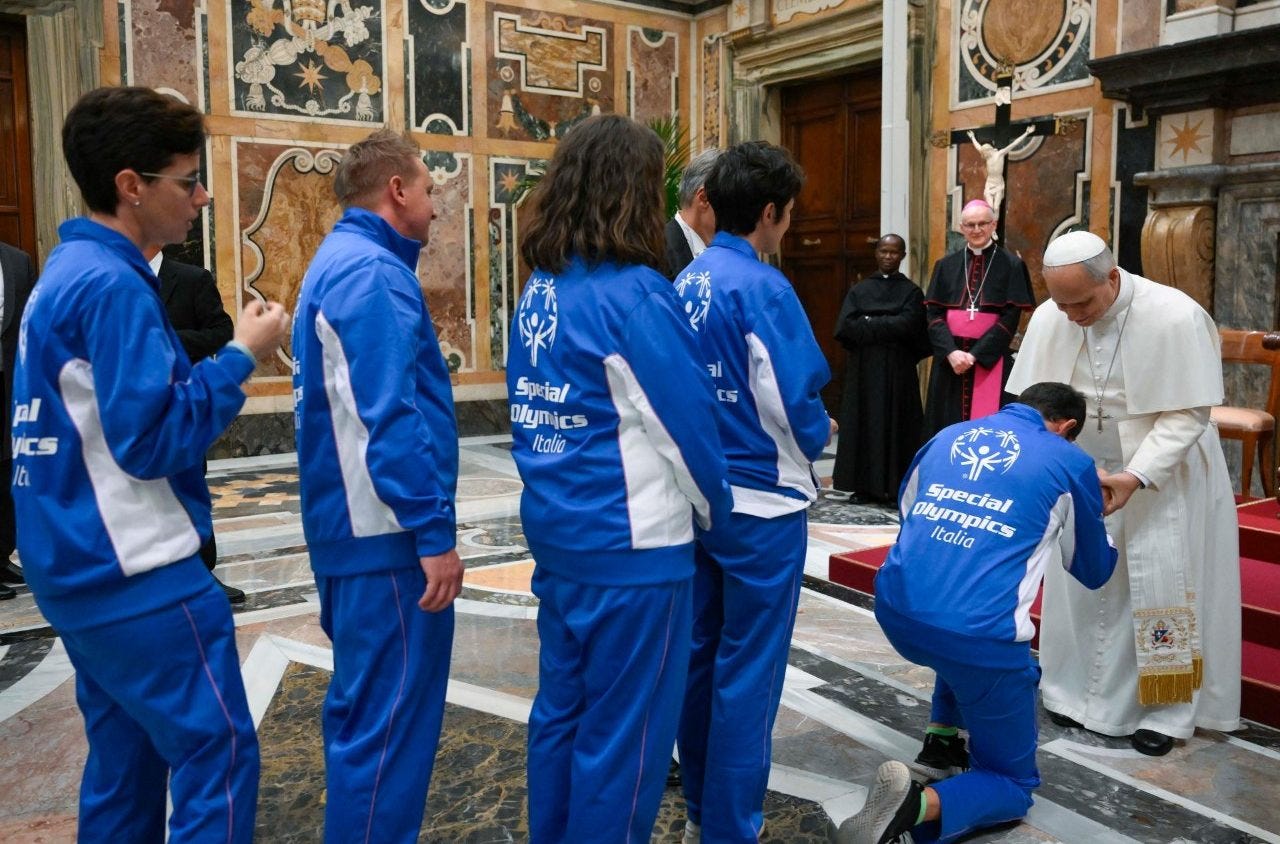 A Special Olympics Italia athlete kneels to greet Pope Leo XIV in the Clementine Hall A Special Olympics Italia athlete kneels to greet Pope Leo XIV in the Clementine Hall