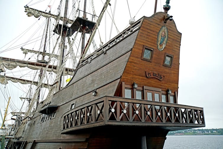The rear of a large wooden sail boat with more than one deck. The rear of a large wooden sail boat with more than one deck.