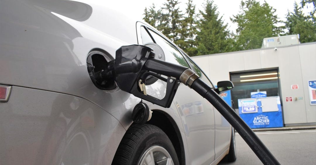 an electric car being charged at a gas station