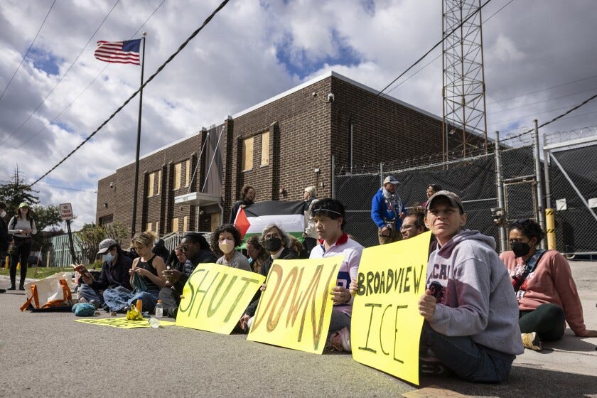 Protesters block the driveway for the U.S. Immigration and Customs Enforcement Agency’s office in Broadview on Friday.