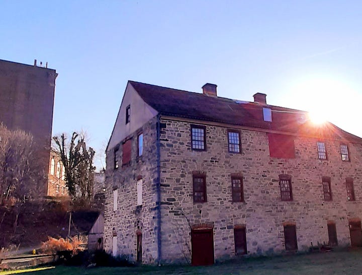 Old stone buildings, including a blacksmith shop, stand in Bethlehem PA.